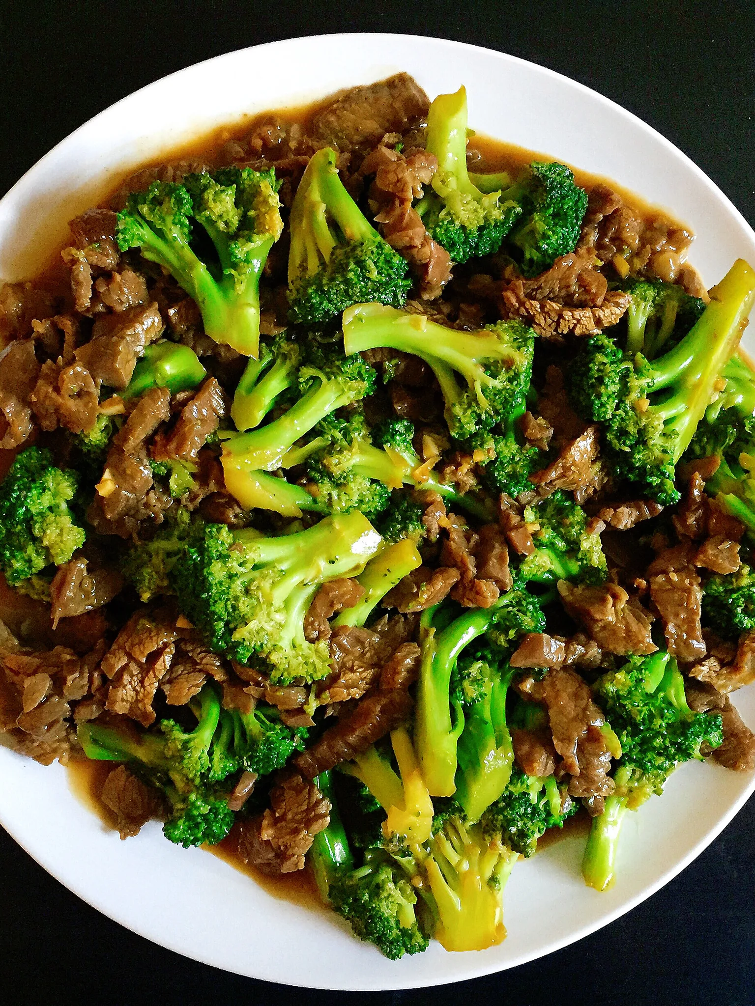 beef and broccoli: A plate of American Chinese beef and broccoli