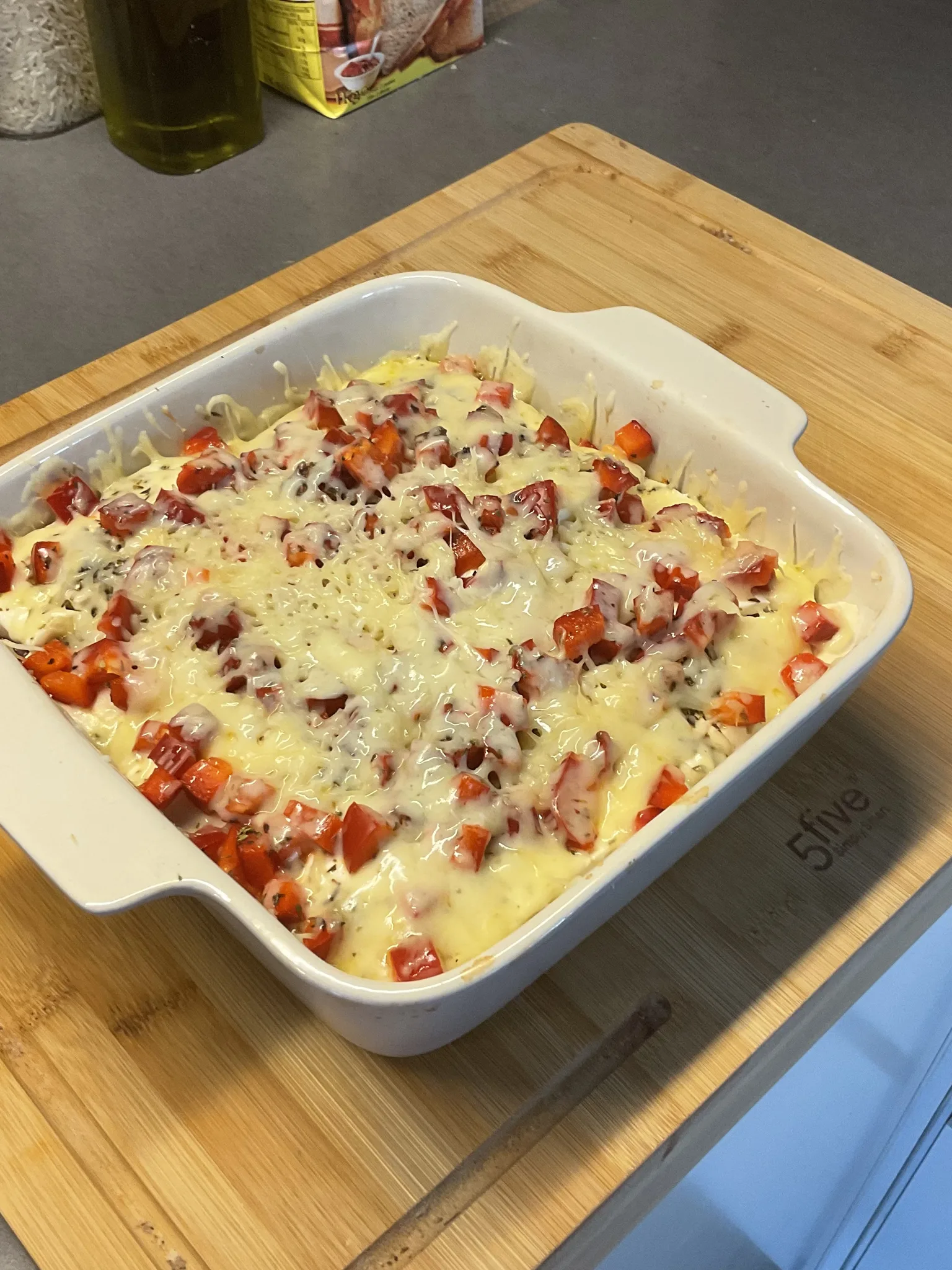 bouyiourdi: Thessalonikian bouyiourdi made in a clay fireproof pan. The recipe consists of feta cheese, yellow cheese, tomatoes, bell pepper, chili pepper, olive oil, oregano, and ground pepper