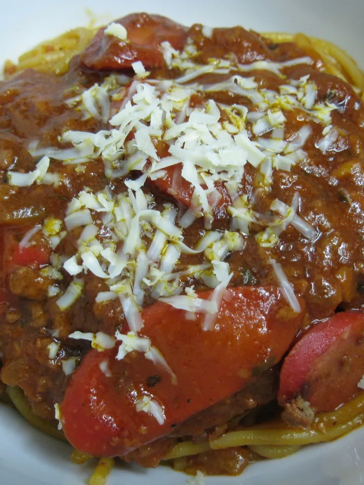 Filipino spaghetti: Red hot dogs, ground beef, Kraft "Cheese" (grated), a single bottle of Jufran Banana Ketchup, a can of Del Monte Traditional Spaghetti Sauce, onions, garlic, brown sugar, salt, pepper