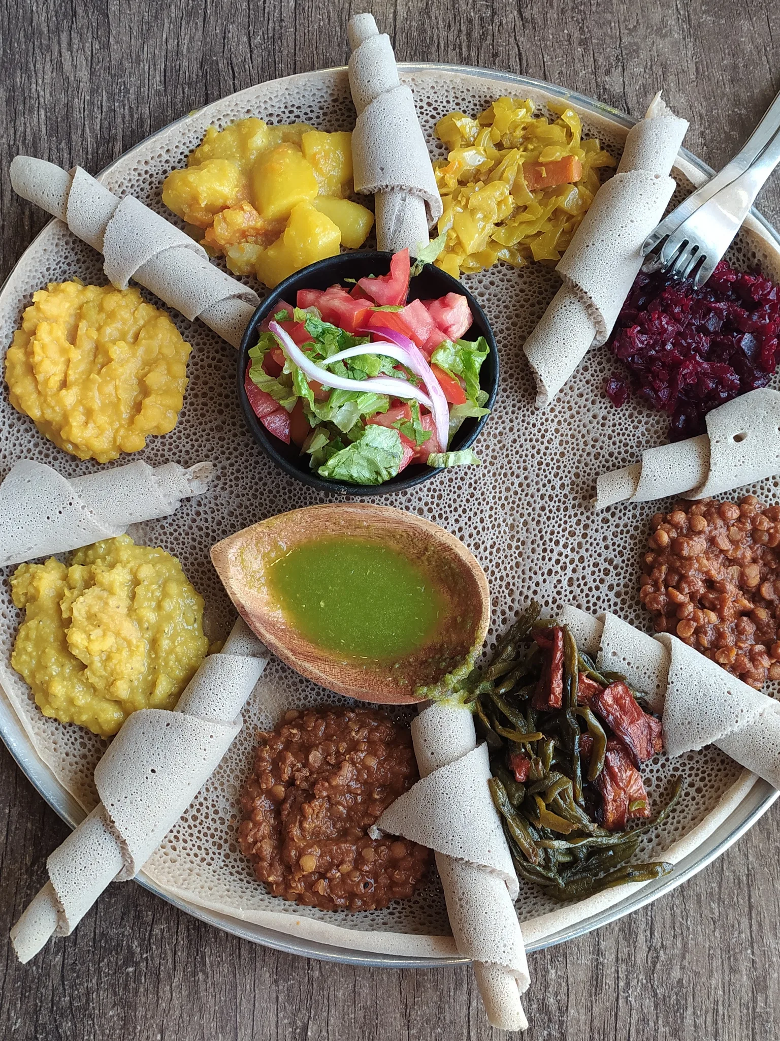 Injera: Injera with eight kinds of stew in an Ethiopian restaurant in Rehovot, Israel