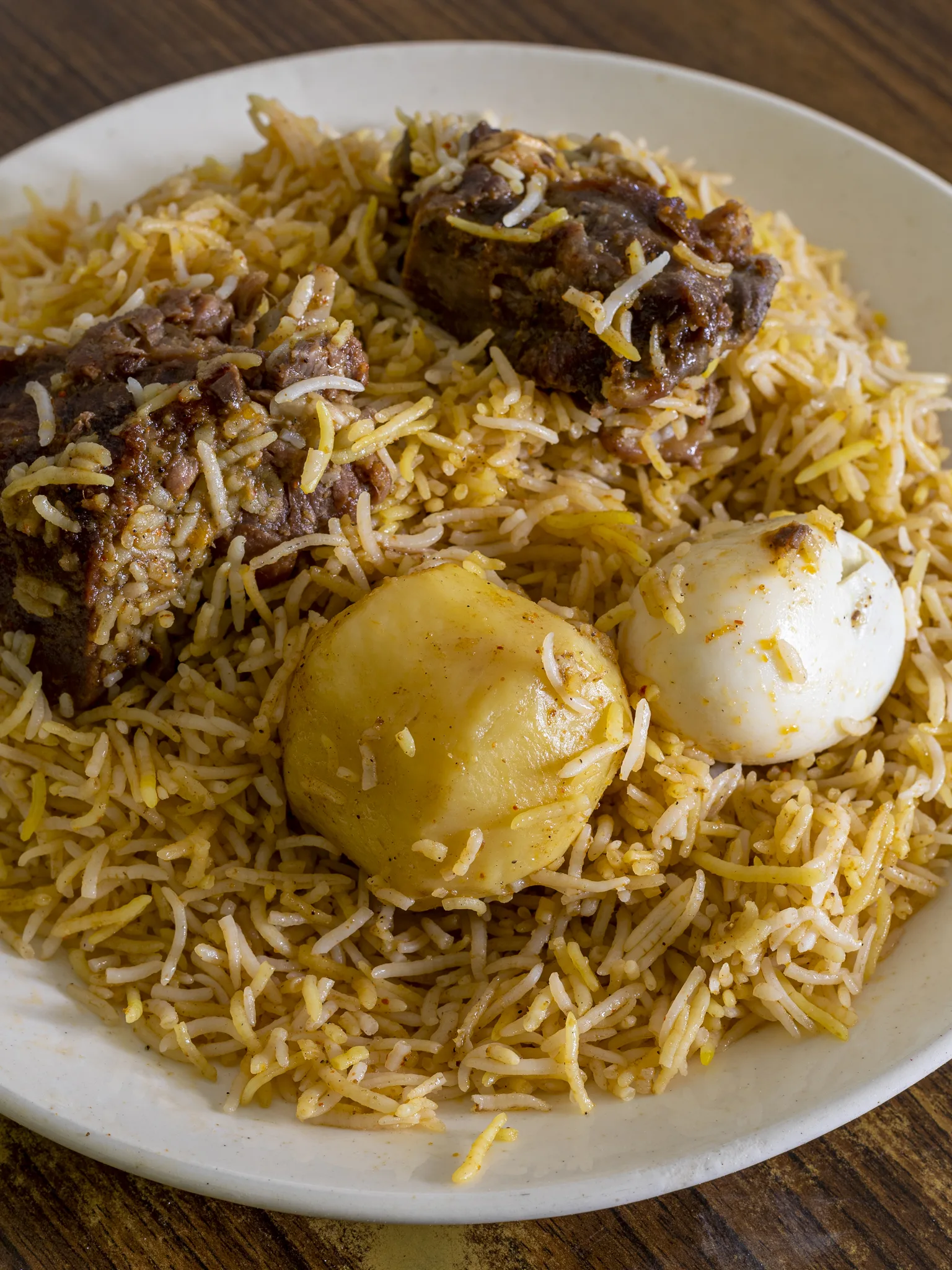 Kolkata biryani: Kolkata Biryani with two pieces of mutton (goat meat), an egg and a potato