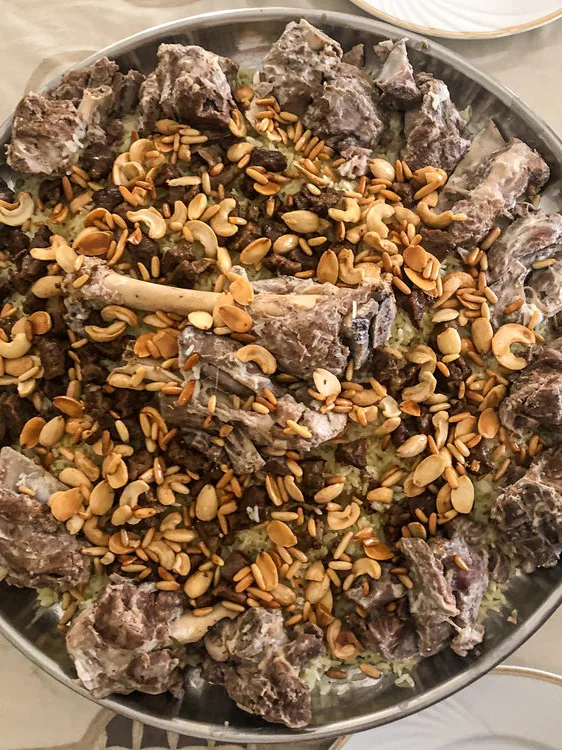 Mansaf: A variant of mansaf in Amman, Jordan made with samneh(ghee)-infused rice and decorated with sauteed nuts alongside jameed-drenched lamb