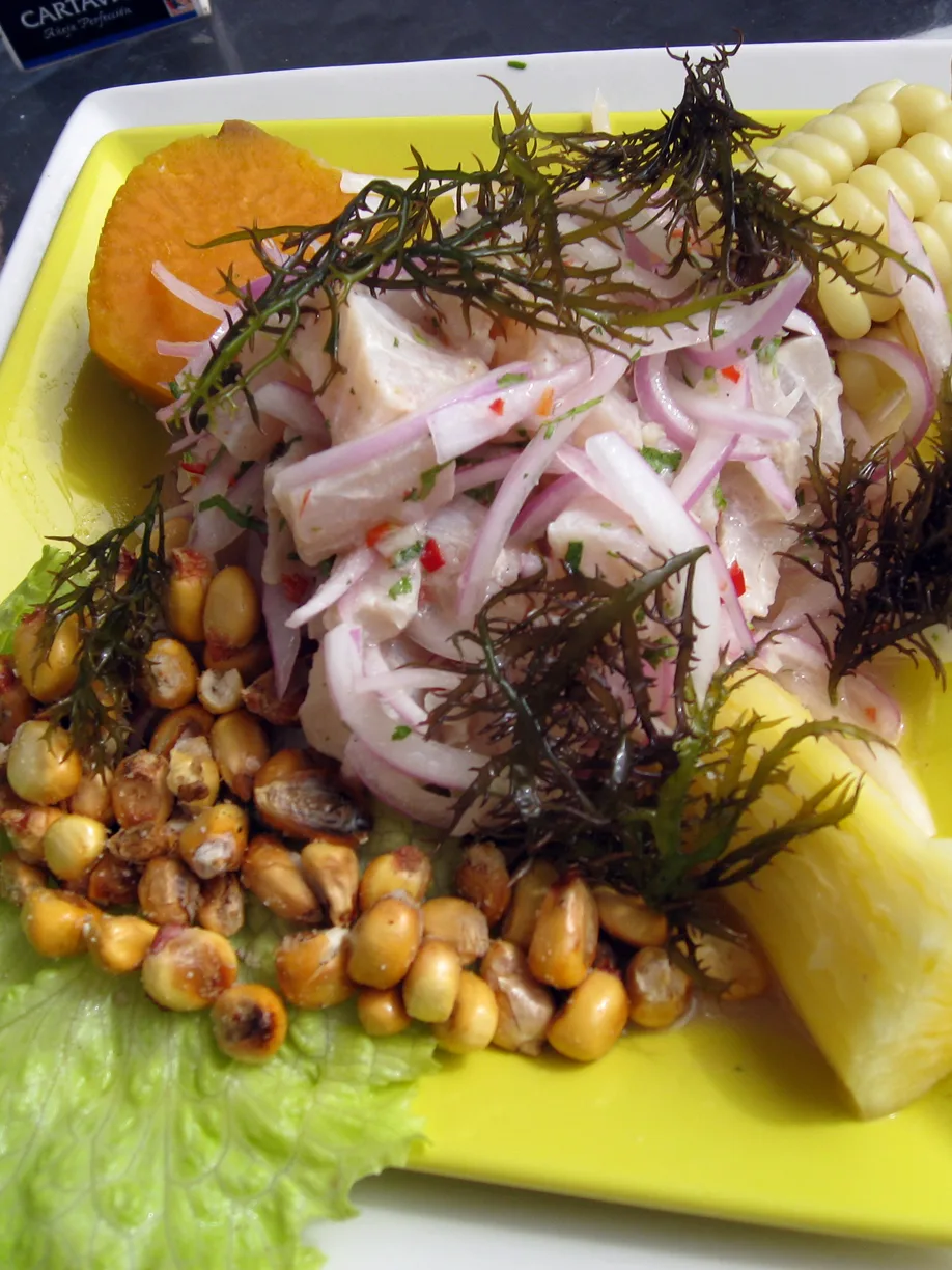 Peruvian ceviche: Fish Ceviche as served in La Punta - Callao (Peru). Note presentation with choclo (maize), yuca (cassava), cancha (toasted maize) and camote (sweet potato), covered with yuyo (sea weed)