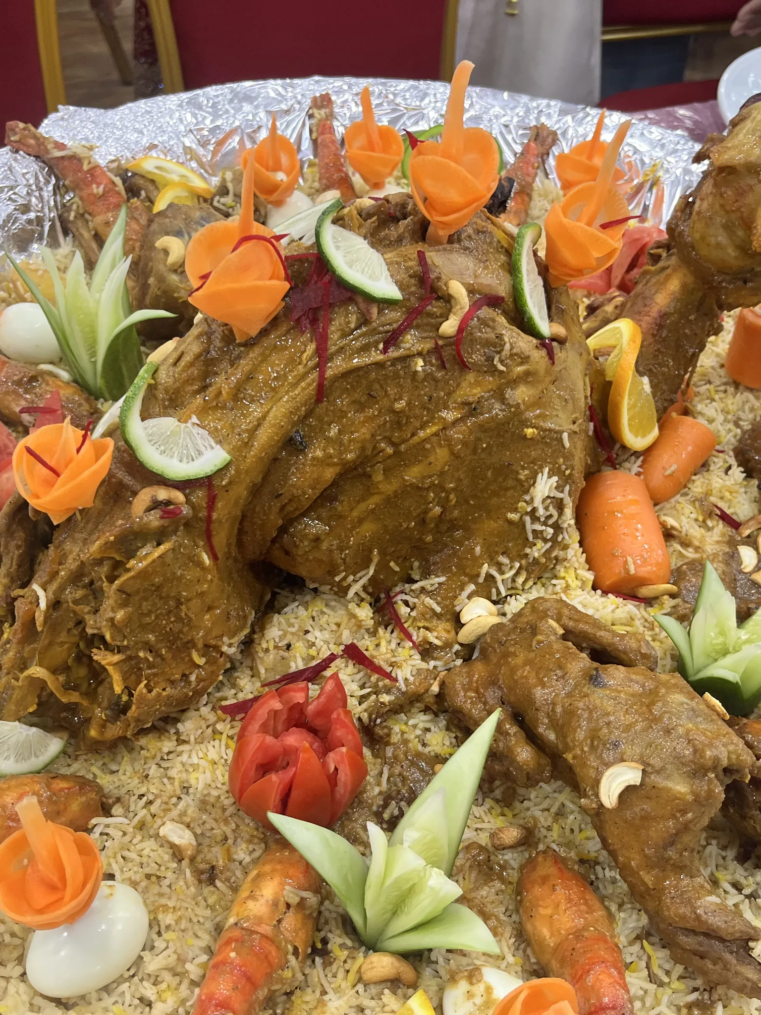 Shagorana: A Shagorana platter served at a Bangladeshi wedding featuring a whole roasted goat, lobsters, chicken roasts, eggs, aromatic polao, and decorative cut salads