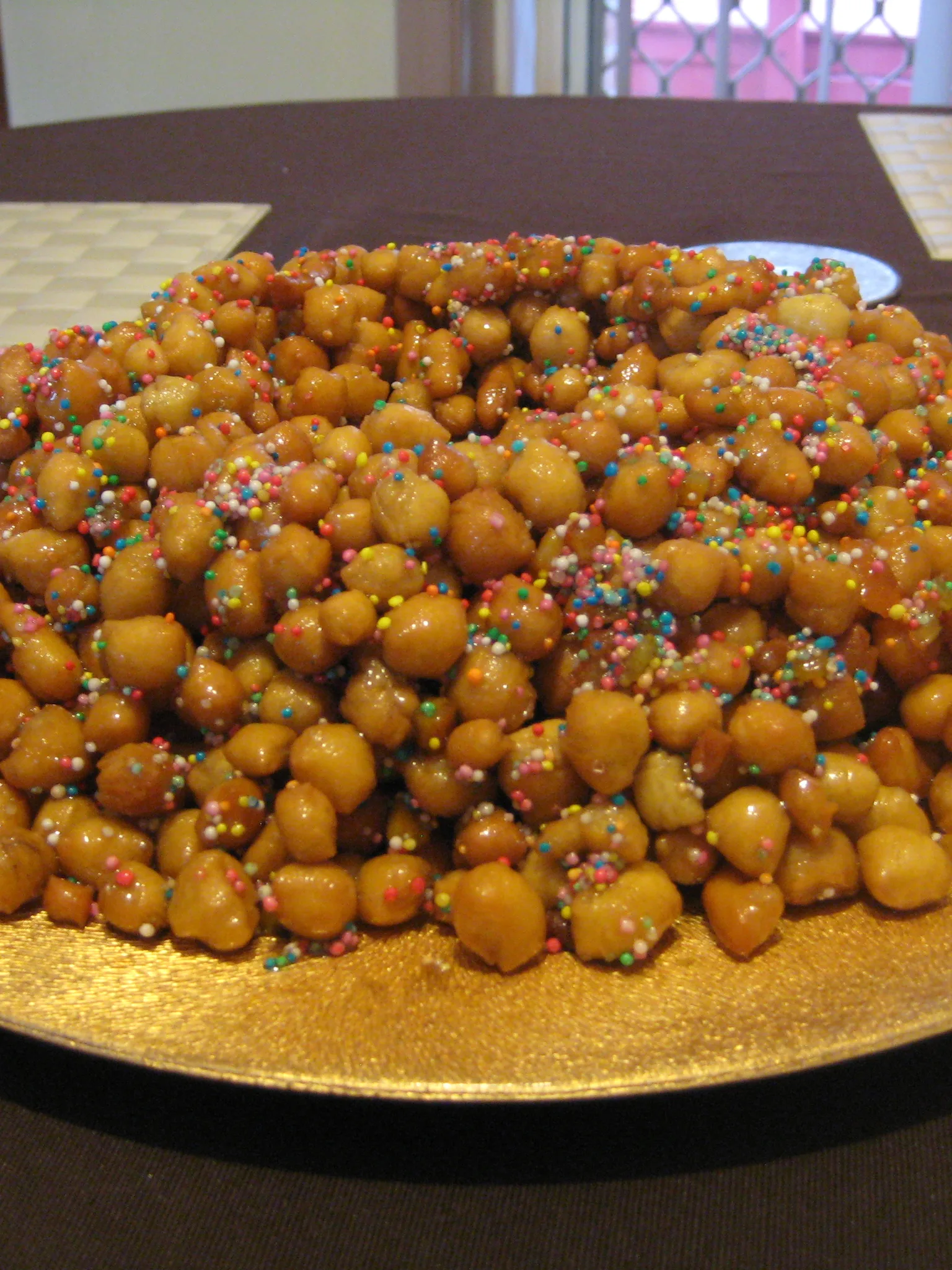 Struffoli: Struffoli made in the traditional way from Sorrento. Marble sized dough balls covered in honey, citrus peel and hundreds and thousands
