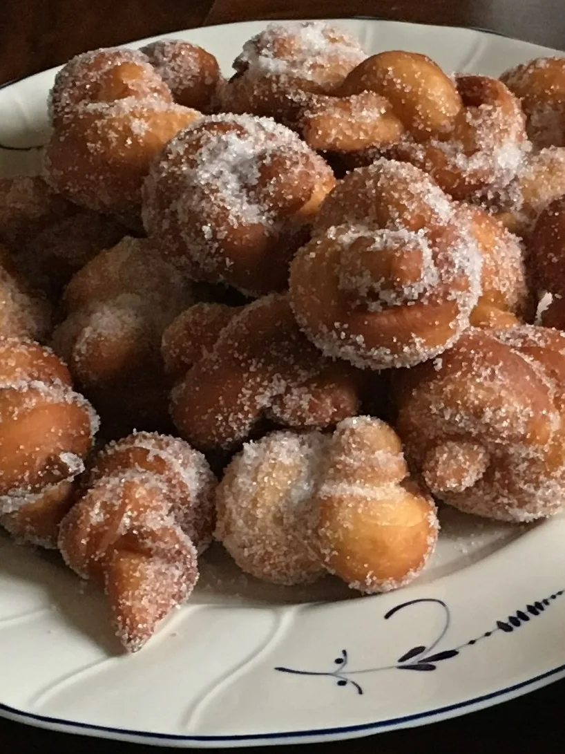 Verwurelter: A traditional Luxembourg pastry made with yeast dough, formed in a knot, fried in hot oil, and coated with granulated or powdered sugar